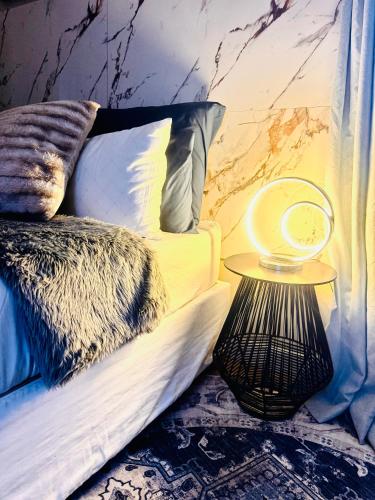a bedroom with a bed with a side table at Private Studio in Cape Town, Near Canal Walk & Table Mountain in Cape Town