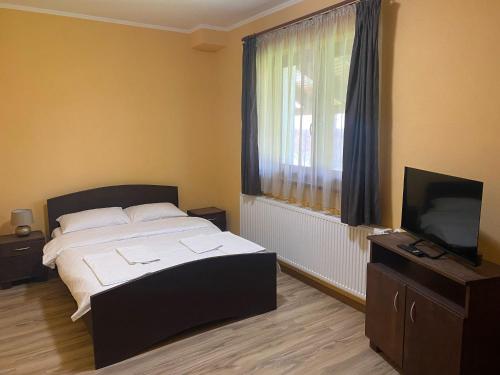 Ένα ή περισσότερα κρεβάτια σε δωμάτιο στο Casa Dragusana