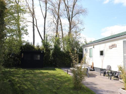 a backyard with a white trailer and a patio at Cottage in Grou with Water Sports Access in Grou