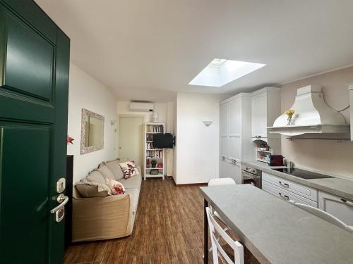 a kitchen and living room with a couch and a table at Two-room apartment 15 minutes from the Duomo in Milan