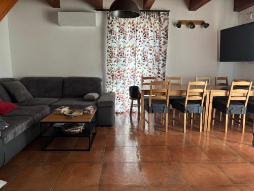 a living room with a couch and a table and chairs at Králíkárna in Králíky