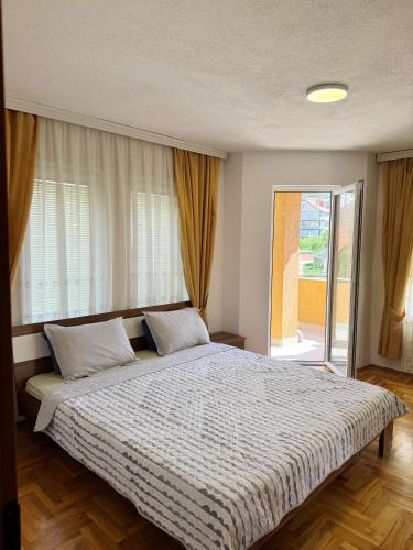 a bedroom with a large bed in front of a window at Prishtina House- Prishtina - Germia in Prishtinë