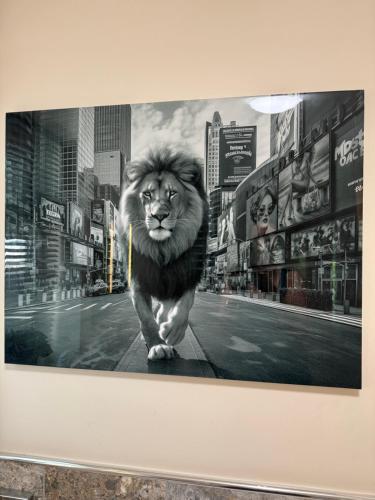 a picture of a lion walking down a city street at Barncroft Luxury Bed & Breakfast in Solihull