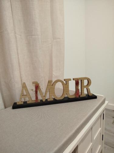 a wooden sign on top of a bed at Casa do Ginjão in Alcobaça
