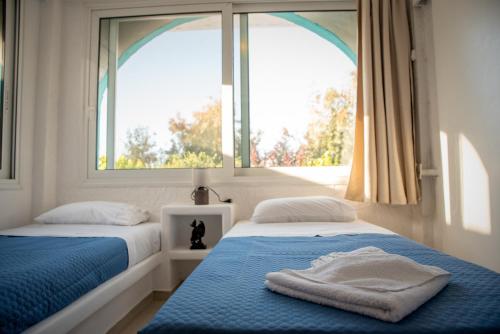 Ένα ή περισσότερα κρεβάτια σε δωμάτιο στο Azzurro Naxos, Azzurro I - Azzurro II - Azzurro III