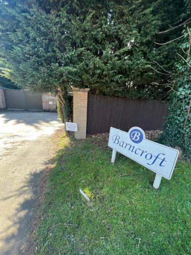 a sign for a bmw dealership sitting in the grass at Barncroft Luxury Bed & Breakfast in Solihull