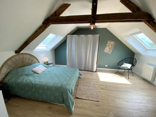 ein Schlafzimmer mit einem Bett auf einem Dachboden in der Unterkunft Villa La Glycine in Saint-Avé