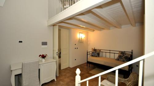 a living room with a bed and a staircase at Don Alfonso Dimora D'epoca in Racale
