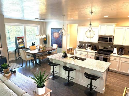 a kitchen and living room with a couch and a table at Hole in One Place with Hot Tub and Ping Pong in Boise