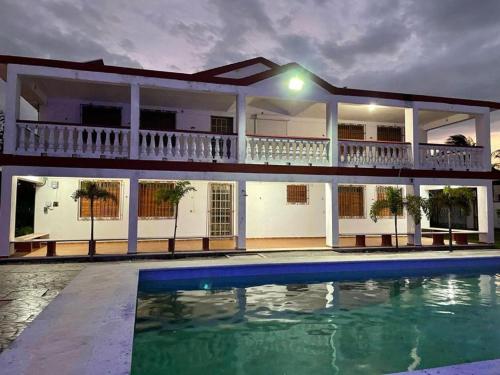 a house with a swimming pool in front of it at Villa Chic in Chicxulub