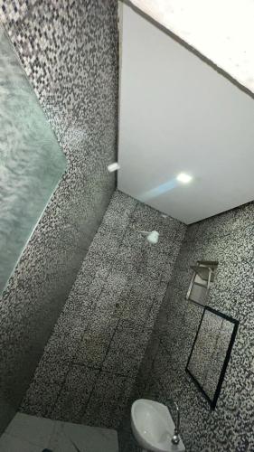 a bathroom with a shower with a sink and a mirror at Hotel rebeka in São Paulo