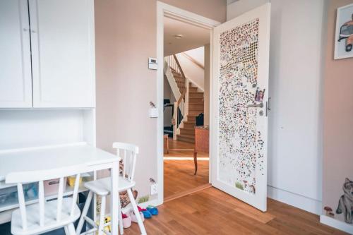 a room with a door with a wall covered in a puzzle at Exklusivt boende med pool & öppen spis in Färjstaden