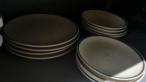 two stacks of plates sitting on a table at Rota do Engawno in Barracão