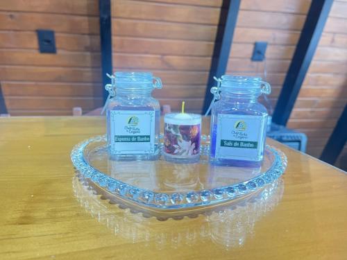 a glass tray with two candles on a table at Rota do Engawno in Barracão