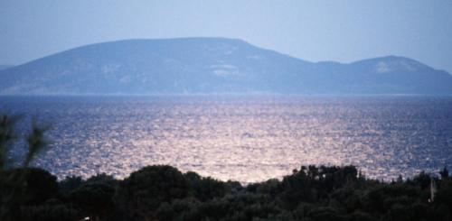 a large body of water with mountains in the background at Apartments Zoumperi in Nea Makri