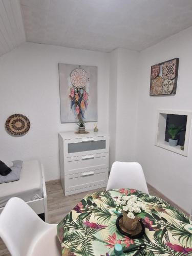 a bedroom with a bed and two chairs and a dresser at Cosy Apartment in City 1 in Kassel