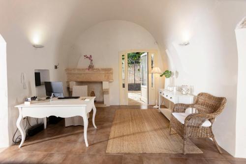 an office with a white desk and a computer in a room at Don Alfonso Dimora D'epoca in Racale
