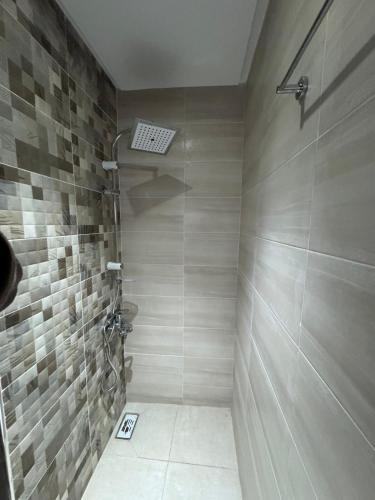 a bathroom with a shower with a tile wall at Chaouen View in Chefchaouene