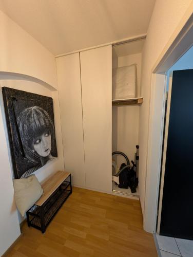a living room with a black and white painting on the wall at Helles Studio mit Arbeitsplatz und Balkon in Chemnitz