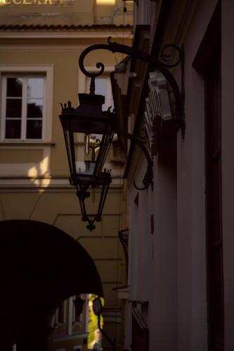 a street light attached to the side of a building at Villa MERLINI w sercu Starego Miasta, Grodzka 19 Lublin in Lublin