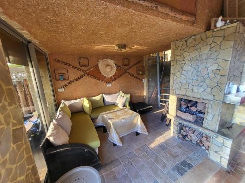 a living room with a couch and a fireplace at Duplex Reposant avec piscine au Andalines Golf Royal Fès in Dar Ito Lahssene
