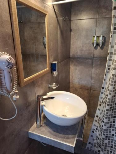 a bathroom with a sink and a shower at Flor de Lis in Capilla del Monte