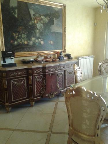 a dining room with a table and a painting on the wall at One M in Borgarello