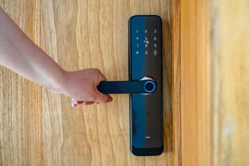 a persons hand unlocking a door with a remote control at Hotel campanario campestre barichara in Barichara
