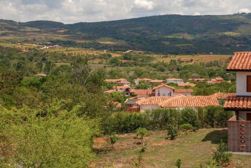 a small village in a valley with mountains at Hotel campanario campestre barichara in Barichara