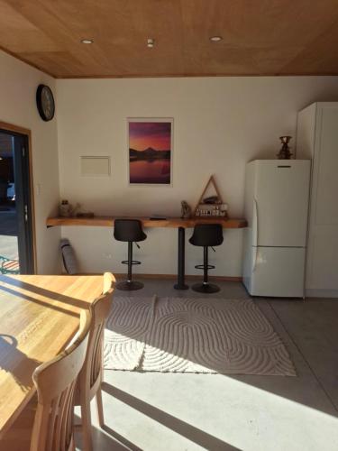 a kitchen with a table and a refrigerator at The Distillery- Lavender Farm Studio apartment in Normanby