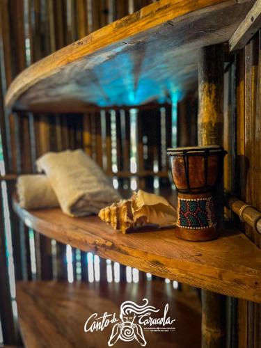 a wooden shelf with pillows and a vase on it at Canto de Caracola in Rincón