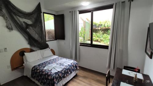 a bedroom with a bed and a window at Pousada Ecomar in Florianópolis
