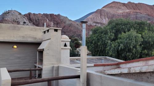 a view of a building with mountains in the background at Cabaña tayta munay in Purmamarca