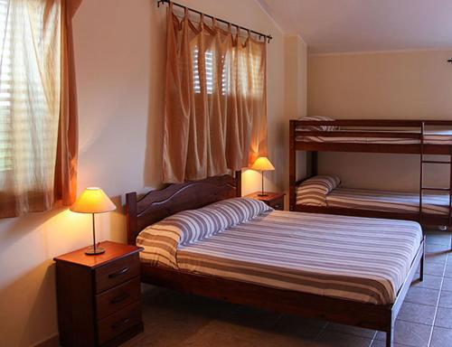 a bedroom with two bunk beds and two lamps at Sicily Country House & Beach in Catania