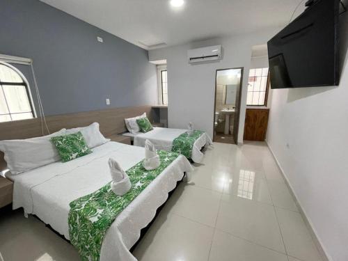 Postel nebo postele na pokoji v ubytování Hotel Xilon Melgar