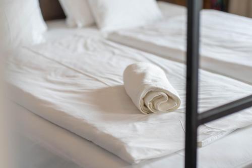 a roll of toilet paper sitting on a bed at Lakeside Apartment Sunset Resort in Fonyód