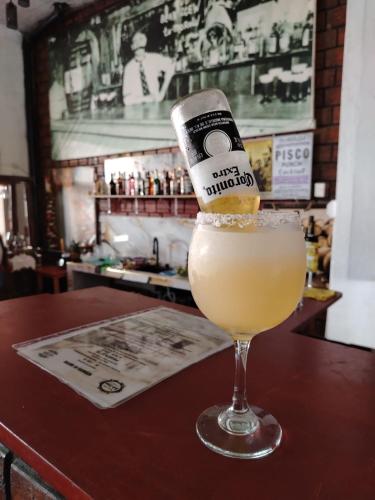 a drink with a bottle in a glass on a bar at La Posada del Cauchero Hotel & Suites in Iquitos