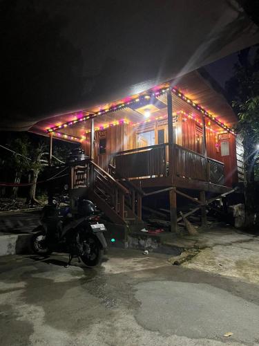 a house with a motorcycle parked in front of it at Ayu Islamic Homestay in Ternate