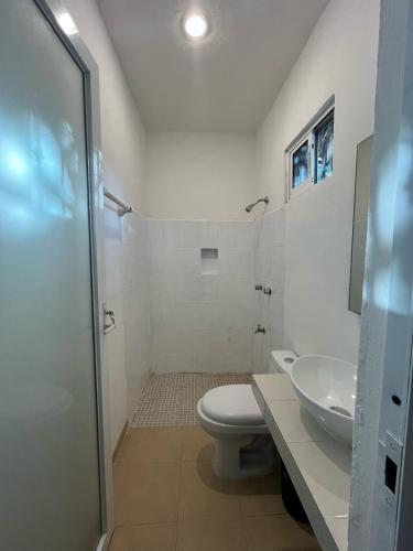 a bathroom with a toilet and a sink at Casa Yaxche 1 in Izamal