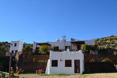 a small white house sitting on top of a hill at Casas Rurales La Minilla in Los Albaricoques