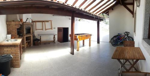 a room with a brick fireplace and a table and a table sidx sidx at Casa de Tapadeiro in Resende