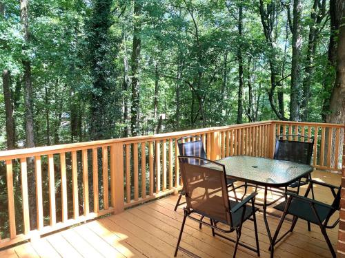 a wooden deck with a table and chairs on it at Paris Mountain Loft Home in Greenville