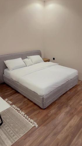 a bed with white sheets and pillows in a room at Quite Studio in Abha