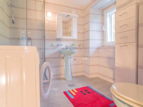 a bathroom with a shower and a sink and a toilet at Holiday Home Danilo in Sveti Stefan