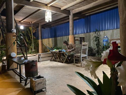 a man sitting at a table in a patio at Berry homestay 1 in Buon Ma Thuot