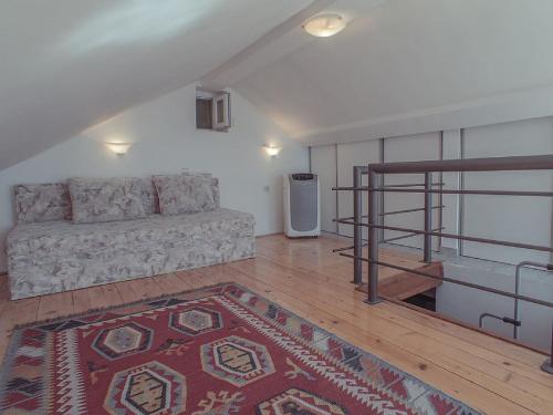 a living room with a couch and a rug at Holiday Home Danilo in Sveti Stefan