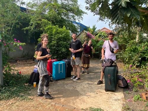 a group of people standing with their luggage at Berry homestay 1 in Buon Ma Thuot