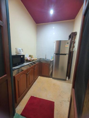 a kitchen with a stainless steel refrigerator and a microwave at The Courtesan at Yaowarat, townhome 80 Sqm in Samphanthawong
