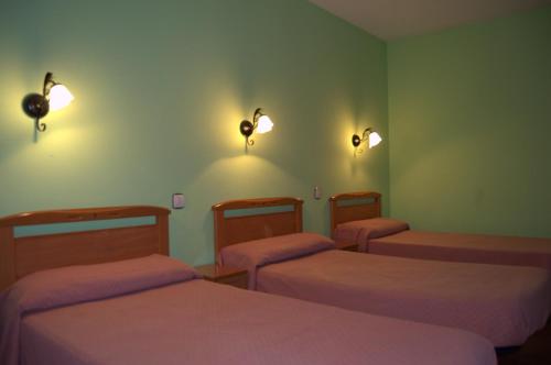 Кровать или кровати в номере Albergue Aurora Boreal