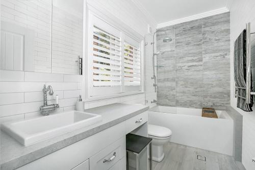 a white bathroom with a sink and a toilet at Balmoral beauty - Elevated living on the esplanade BALO1 in Sydney